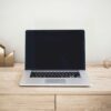 MacBook Pro on top of brown table